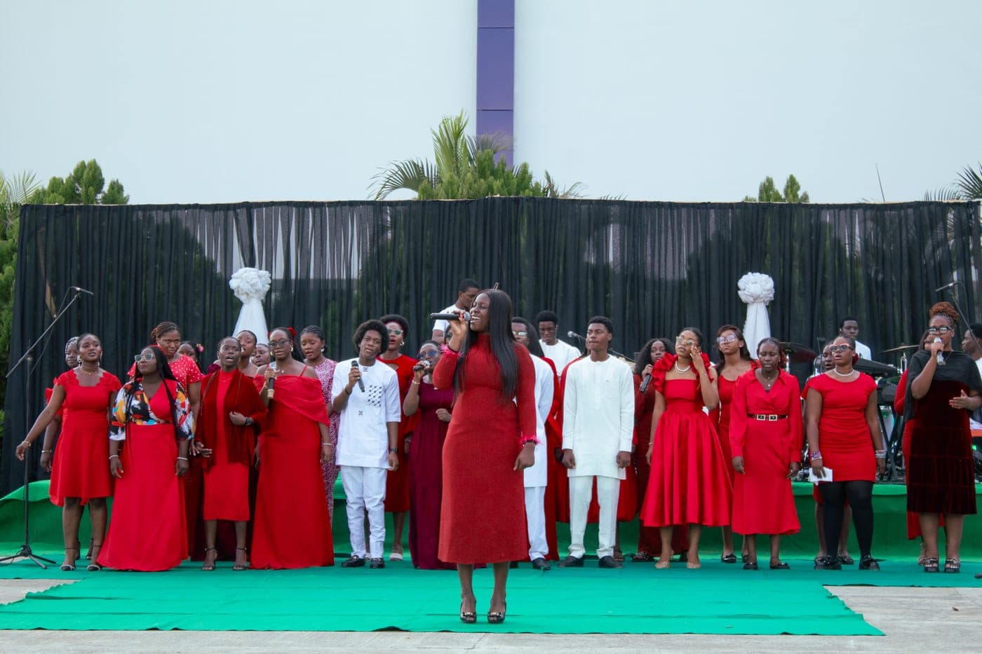 The choir dressed in red performing at the Christmas Carol service