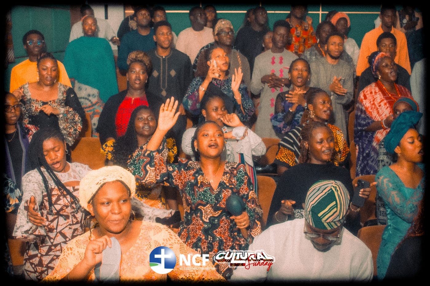 A crowd of students worshipping in traditional dress on Cultural Sunday