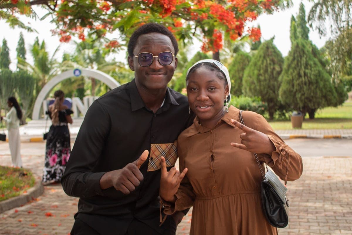Two students posing together on the Nile University campus