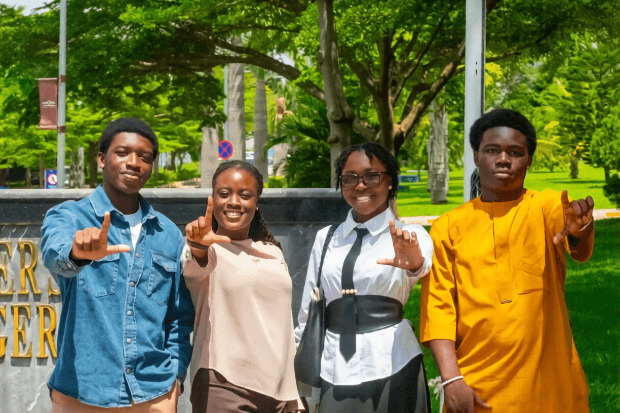 Four students standing together on the Nile University campus