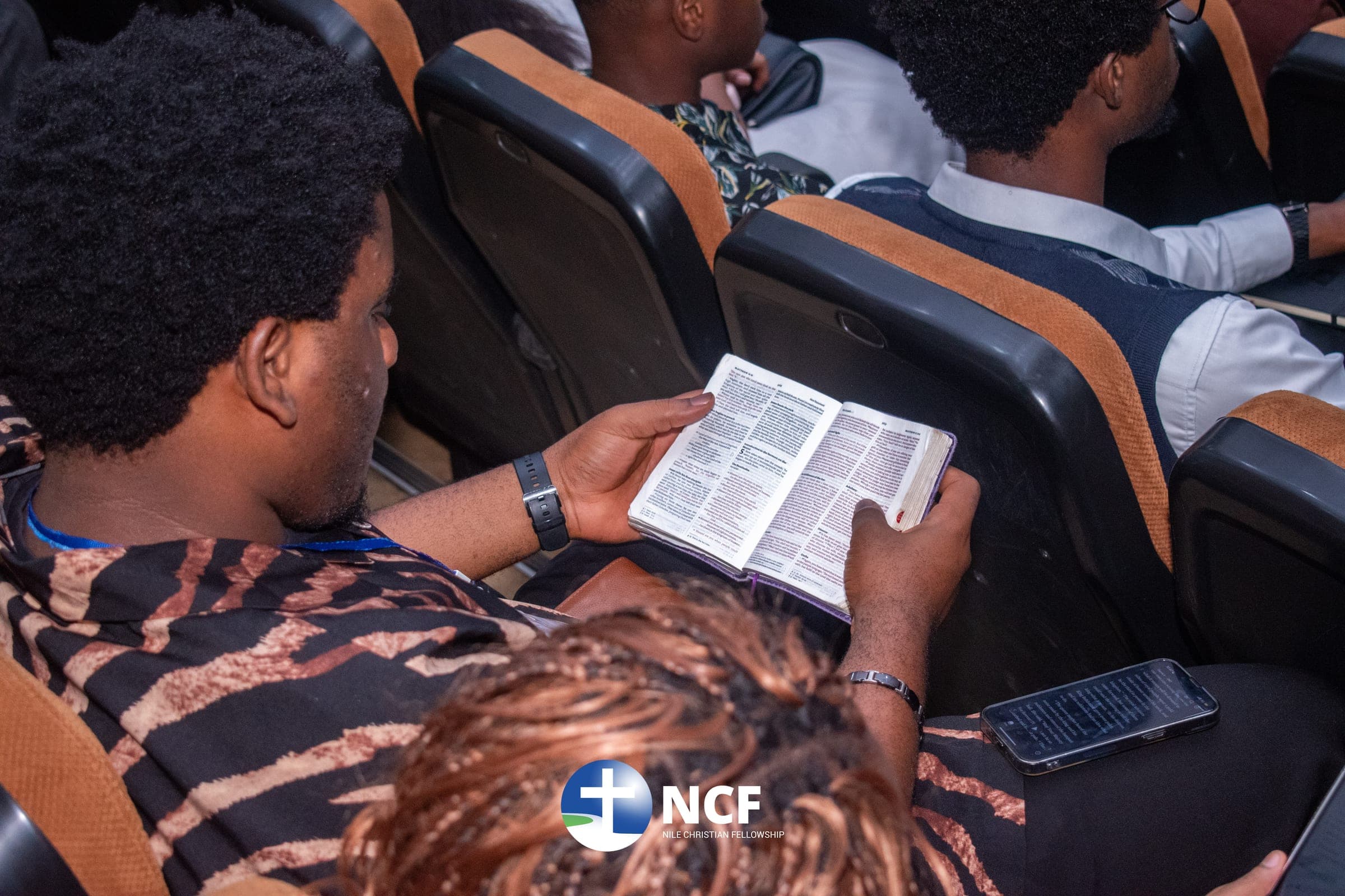 A student reading their Bible during a service