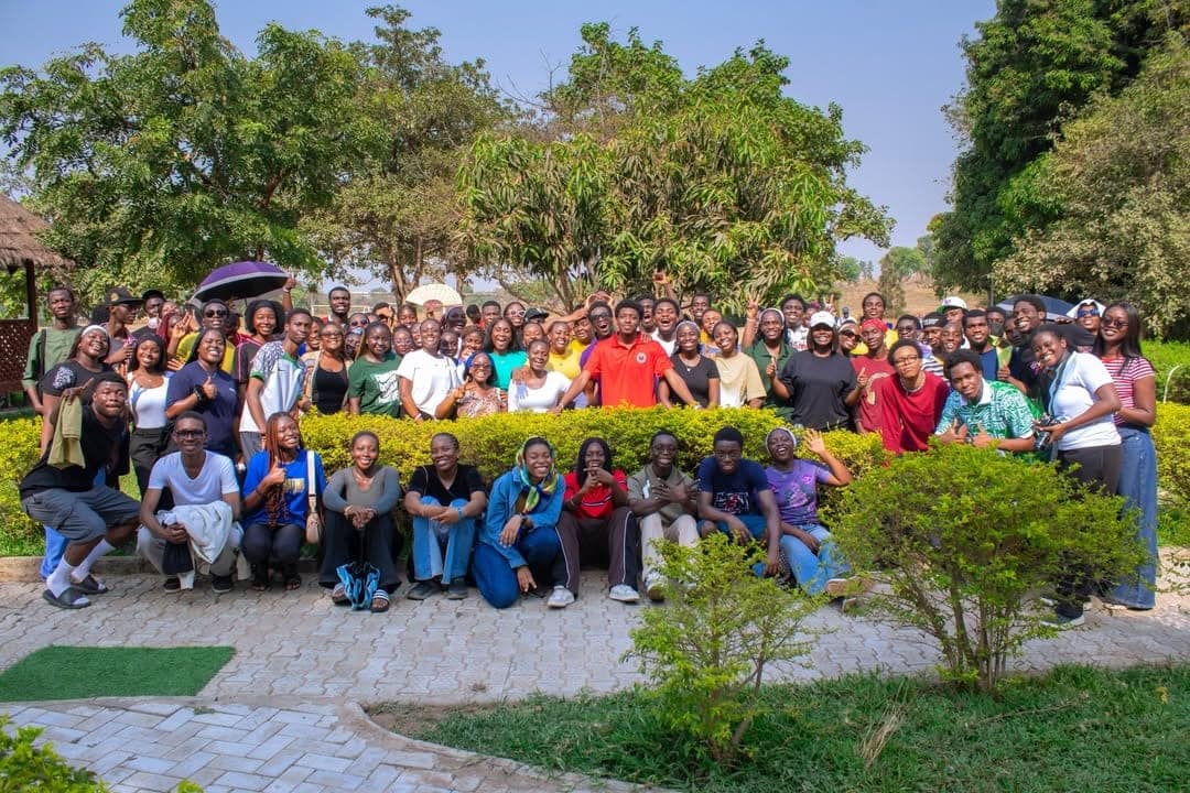 The Nile Christian Fellowship community gathered outdoors for a group photograph